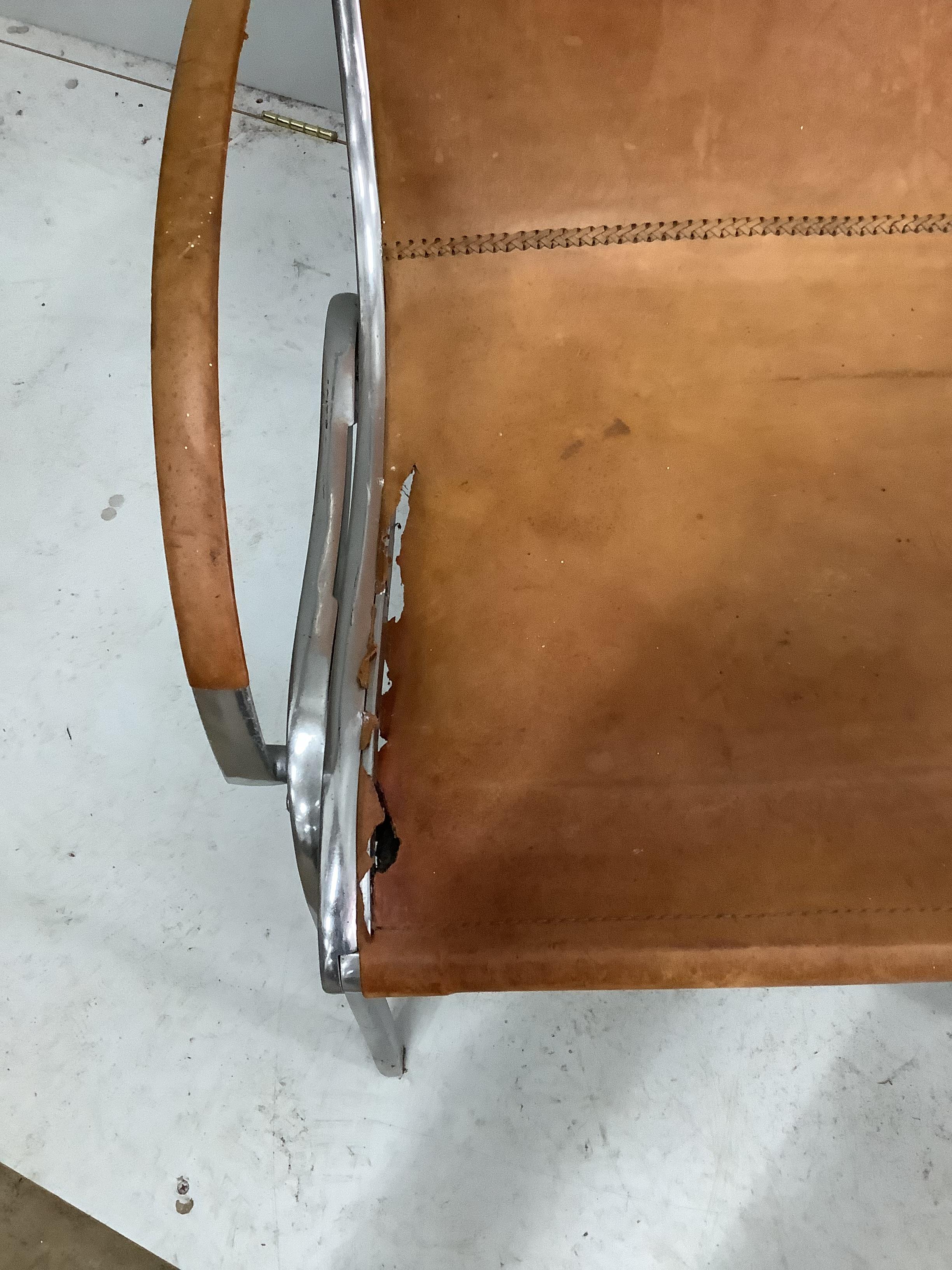 An aluminium and tan leather armchair in the manner of Rodolf Szedleczky (seat in need of repair), width 65cm, depth 84cm, height 94cm